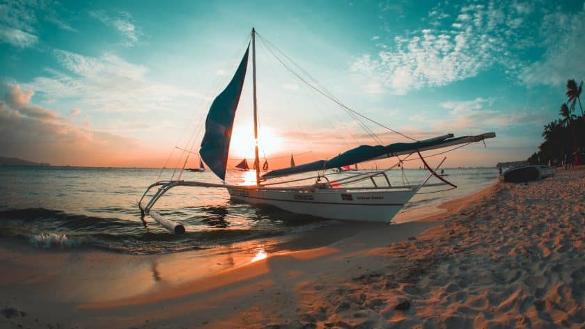 white boat docked on seashore