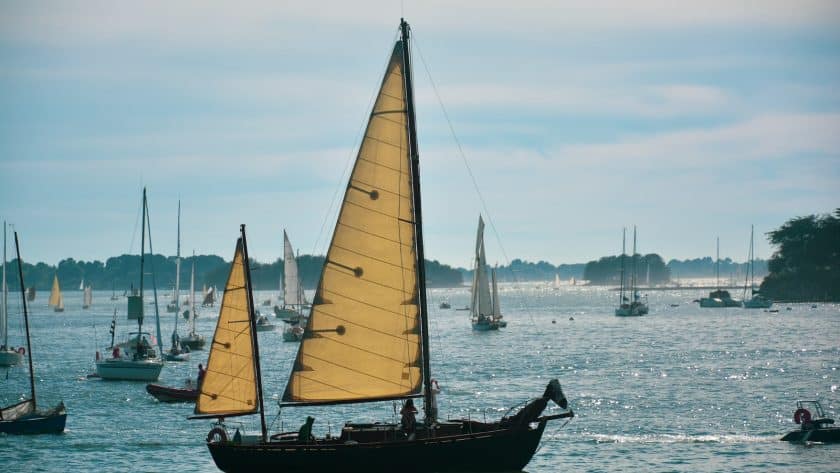 brown and white sail boat on sea during daytime