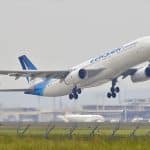 white and blue airplane about to fly at the airport