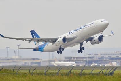 white and blue airplane about to fly at the airport