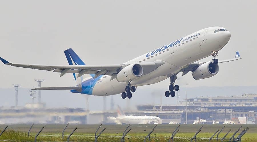 white and blue airplane about to fly at the airport